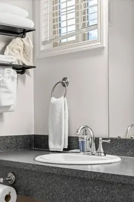 a bathroom counter with a sink and a towel at Charming Condo In The Heart Of Canmore in Canmore