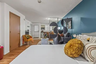 a bedroom with a bed and a blue wall at Stylish Getaway in the Heart of Canmore near Banff in Canmore