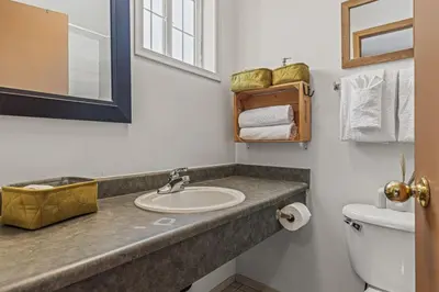 a bathroom with a sink and a toilet at Stylish Getaway in the Heart of Canmore near Banff in Canmore