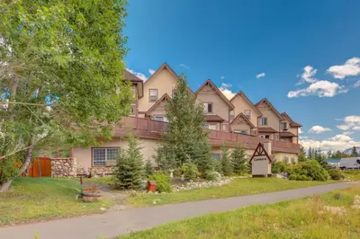 a large house with a driveway in front of it at Stylish Getaway in the Heart of Canmore near Banff in Canmore