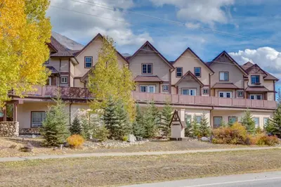 a large house with a row of houses at Delightful 2BR Mountain Escape in Canmore in Canmore