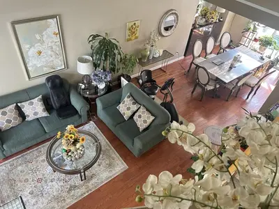 a living room with a couch and a dining room at Luxury & Spacious three bedrooms House Near Coquitlam Town Centre in Coquitlam