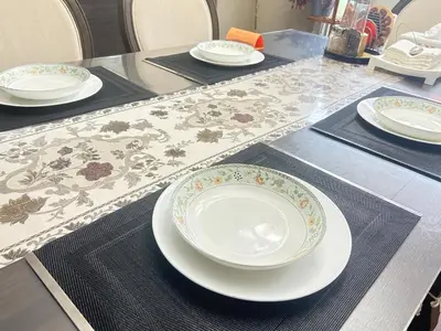 a table topped with plates and bowls on a table at Luxury & Spacious three bedrooms House Near Coquitlam Town Centre in Coquitlam