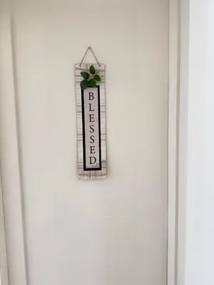 a sign on a white door with a plant on it at Cozy Private Room near Langara College Skytrain Station in Vancouver