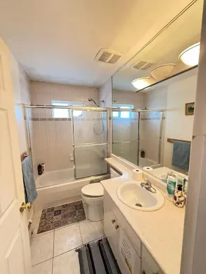 a bathroom with a sink and a toilet and a tub at Cozy Private Room near Langara College Skytrain Station in Vancouver