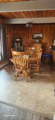 a wooden dining room with a table and chairs at Brown Family Farm in Grand Forks