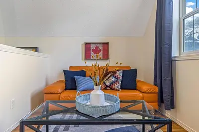 a living room with a couch and a glass table at Traveler Friendly Canmore Condo Close to Banff in Canmore