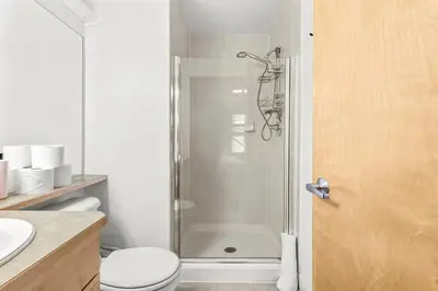 a bathroom with a shower with a toilet and a sink at Mesmerizing 2BR Retreat Made For You in Canmore