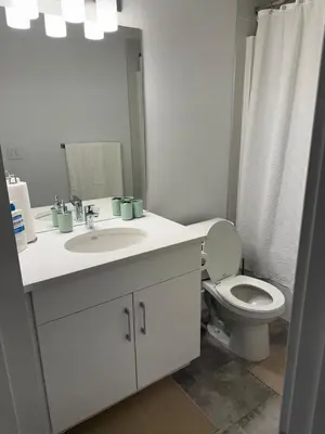 a bathroom with a white sink and a toilet at Peace Haven in Edmonton