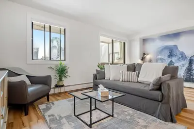 a living room with a couch and a table at Peaceful DT Condo, Saddledome, HeatedParking in Calgary