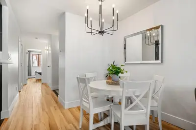 a dining room with a white table and chairs at Peaceful DT Condo, Saddledome, HeatedParking in Calgary