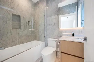 a bathroom with a toilet and a tub and a sink at Luxury & brand-new Cozy duplex in South Vancouver in Vancouver