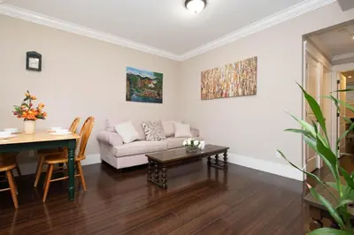 a living room with a couch and a table at Cozy 3 BR Suite Ideal for Families and Groups in Vancouver