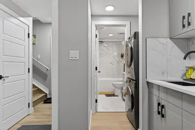a white kitchen with a sink and a toilet at Guest Suite in Edmonton, King bed and parking in Edmonton