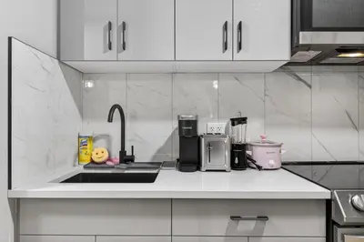 a kitchen with white cabinets and a counter top at Guest Suite in Edmonton, King bed and parking in Edmonton