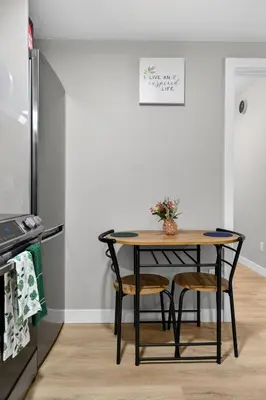 a kitchen with a table and chairs and a refrigerator at Guest Suite in Edmonton, King bed and parking in Edmonton