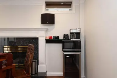 a kitchen with a fireplace with a microwave and a stove at Comfort Spacious 2-BR Suite in Arbutus in Vancouver