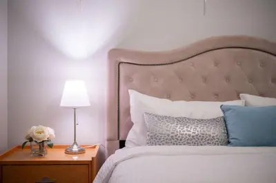 a bedroom with a bed and a lamp on a night stand at Comfort Spacious 2-BR Suite in Arbutus in Vancouver
