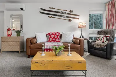 a living room with a couch and a coffee table at 1BR + Sofa Bed | Greystone Lodge | Ski in / Ski out | Pool & Hot Tub | Epic Locations in Whistler