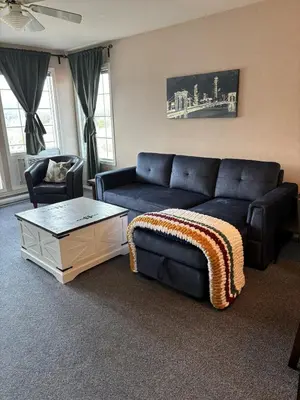 a living room with a blue couch and a coffee table at Cozy getaway with a view! in Fairmont Hot Springs