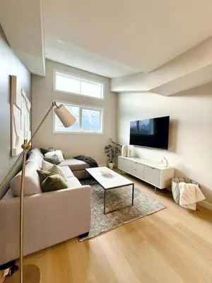 a living room with a couch and a tv at Mountain Retreat with Views and Hot Tub Near Banff Gates in Canmore