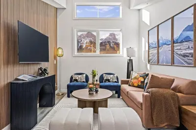a living room with a couch and a fireplace at Cozy 3BR Mountainside Haven Near Banff in Canmore