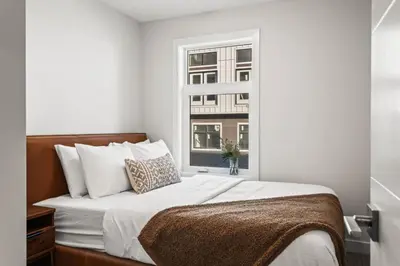 a bedroom with a large bed with a window at Cozy 3BR Mountainside Haven Near Banff in Canmore