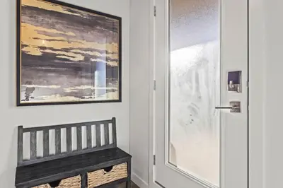 a door with a bench next to a window at Cozy 3BR Mountainside Haven Near Banff in Canmore
