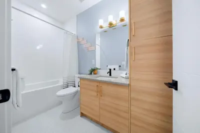 a bathroom with a sink and a toilet and a mirror at Scenic 3BR Townhouse with Mountain Views Near Banff in Canmore