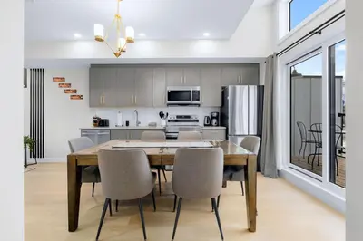 a kitchen and dining room with a table and chairs at Scenic 3BR Townhouse with Mountain Views Near Banff in Canmore