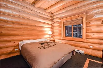 a bedroom with a bed in a log cabin at Authentic, Timber Log Cabin Perfect for Groups in Golden