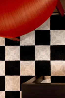 a black and white checkered floor with a red pillow at Retro-Chic Hideaway - Walking Distance To Stampede in Calgary