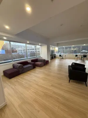 a large living room with couches and tables and windows at Luxury Downtown One Bedroom with Skyline Views and Free Parking in Edmonton