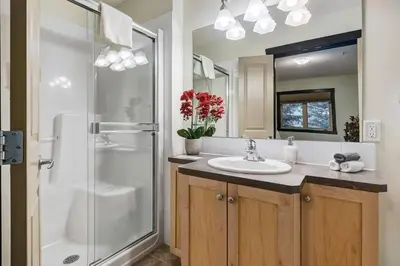 a bathroom with a sink and a shower at Heated Outdoor Pool Near Banff Park in Canmore
