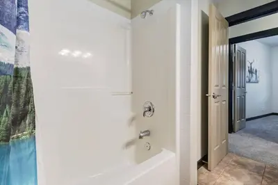 a bathroom with a tub and a shower at Heated Outdoor Pool Near Banff Park in Canmore