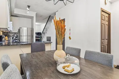 a dining room table with a plate of food on it at Stylish Mountain Retreat 2BR Chalet and Hot Pool in Canmore