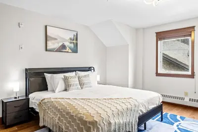 a bedroom with a large bed and a window at 2BR MTN Canmore Retreat with Private Balcony in Canmore