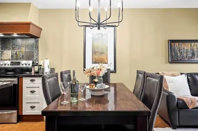 a dining room with a table and chairs at Serene 2BR Solara Escape with BBQ Pool and Hot Tub in Canmore