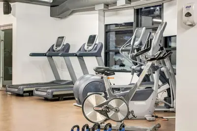 a gym with several cardio machines and a bike at Serene 2BR Solara Escape with BBQ Pool and Hot Tub in Canmore