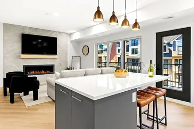 a kitchen and living room with a fireplace at 3BR Rockies Have Sleeps 8 with Hot Tub Pool and Mtn Views in Canmore