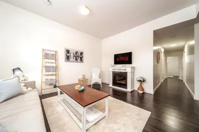 a living room with a couch and a fireplace at 3BDRM Winter Haven - King Beds - Fireplace - Garage in Edmonton