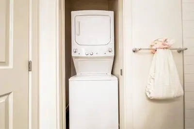 a washer and dryer next to a door at 3BDRM Winter Haven - King Beds - Fireplace - Garage in Edmonton