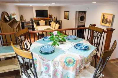 a dining room table with plates and flowers on it at Luxury Home by White Rock in Surrey