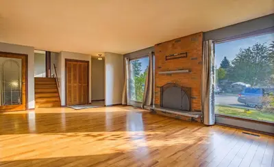 an empty room with a fireplace in a house at Fully furnished House near GrayNuns, Millwoods in Edmonton