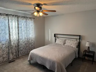 a bedroom with a bed and a ceiling fan at Fully furnished House near GrayNuns, Millwoods in Edmonton