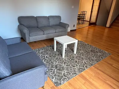 a living room with a couch and a table at All what you need in a House near GrayNuns, Millwoods in Edmonton