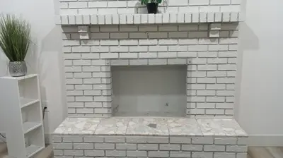 a white brick fireplace with a plant on top at Vancouver Downtown Guest House- Walk to Skytrain & BC Place- Free Parking in Vancouver