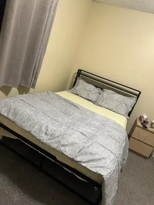 a small bed in a bedroom with a window at Private room in Edmonton