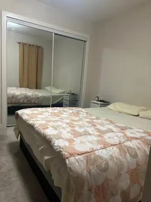 a bedroom with a bed and a large mirror at Private room in Edmonton