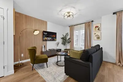 a living room with a couch and a table at luxury Play House Sleeps 12 Keswick in Edmonton